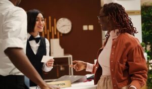 hotel receptionist warmly welcoming guests during on site hospitality training