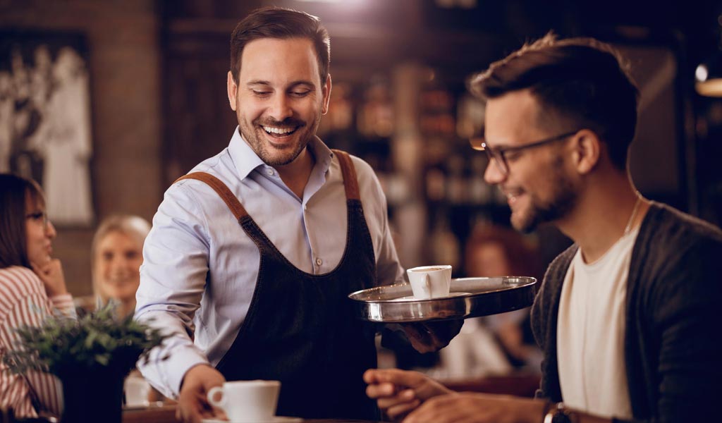 Waiter serving coffee
